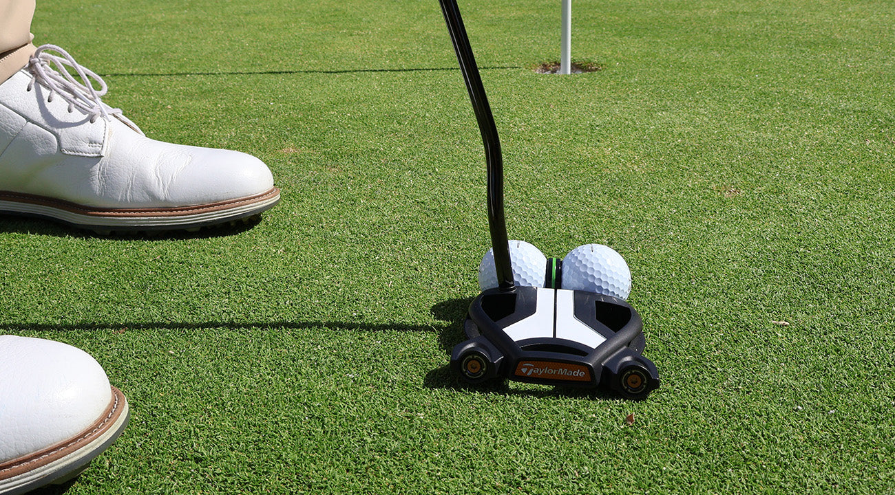 Golfer putting through thePuttGPT toward the hole on the practice green